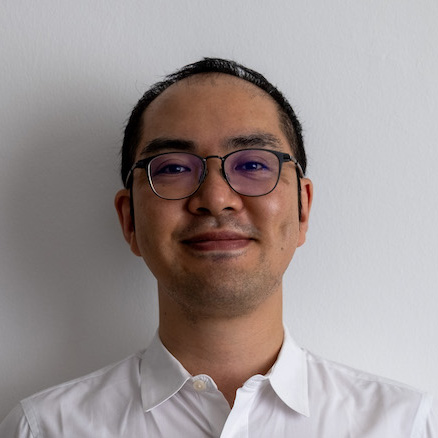 A picture of Kotaro, an asian man with short black hair and glasses, wearing a white shirt.