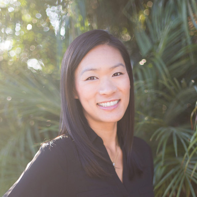 Picture of Kristen, an asian woman with black hair, wearing a black collared shirt.